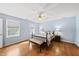Charming main bedroom with light blue walls, hardwood floors, and a ceiling fan with plenty of natural light at 101 Conway Ct, Cary, NC 27513