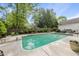 Refreshing in-ground pool with diving board and ladder, surrounded by lush landscaping and a privacy fence at 101 Conway Ct, Cary, NC 27513