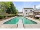 Beautiful in-ground pool with diving board nestled in a private backyard with mature trees and a white two-story home at 101 Conway Ct, Cary, NC 27513
