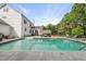 A well-maintained in-ground pool is the focal point of this spacious backyard with comfortable seating under a pergola at 101 Conway Ct, Cary, NC 27513