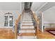 Beautiful staircase with hardwood steps and decorative wrought iron spindles, creating a warm and inviting ambiance at 101 Conway Ct, Cary, NC 27513