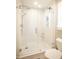 Bright bathroom with a glass shower door, gray tile flooring and a built-in shower caddy at 101 Lakeshore Dr. Dr, Durham, NC 27713