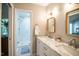 Bright bathroom featuring double sinks, marble countertops, framed mirrors and tiled walk-in shower at 101 Lakeshore Dr. Dr, Durham, NC 27713