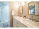 Bright bathroom with marble countertops, double vanity, gold hardware and a walk-in shower at 101 Lakeshore Dr. Dr, Durham, NC 27713