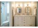 Modern bathroom featuring a double vanity, stylish mirrors, and a glass-enclosed shower at 101 Lakeshore Dr. Dr, Durham, NC 27713