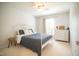 Bright bedroom with a ceiling fan, area rug, and a white metal bed frame and dresser at 101 Lakeshore Dr. Dr, Durham, NC 27713