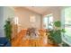 Bright dining area features hardwood floors, a glass top table, and large windows at 101 Lakeshore Dr. Dr, Durham, NC 27713