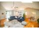 Open concept living room showcasing hardwood floors, a large blue sectional and bright dining area at 101 Lakeshore Dr. Dr, Durham, NC 27713