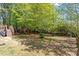 Spacious backyard featuring a wooden deck and bordered by a charming wooden fence at 1021 S Fieldhaven Dr, Fuquay Varina, NC 27526