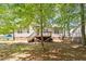 Exterior shot from the backyard shows well maintained lawn and a charming deck at 1021 S Fieldhaven Dr, Fuquay Varina, NC 27526