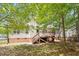 A view of the home's rear exterior shows a wooden deck, back siding, and shaded backyard at 1021 S Fieldhaven Dr, Fuquay Varina, NC 27526