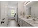 Bright bathroom features dual sinks, vanity, and neutral decor at 1021 S Fieldhaven Dr, Fuquay Varina, NC 27526