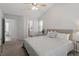 Spacious bedroom with neutral décor, large bed, and view to ensuite bathroom at 1021 S Fieldhaven Dr, Fuquay Varina, NC 27526