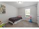 Cozy bedroom features playful decor, window, and plush carpet at 1021 S Fieldhaven Dr, Fuquay Varina, NC 27526