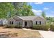 Attractive single-Gathering home with a well-maintained lawn, mature trees and a driveway at 1021 S Fieldhaven Dr, Fuquay Varina, NC 27526