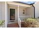 Close-up of the front porch featuring a dark front door and white railing at 1021 S Fieldhaven Dr, Fuquay Varina, NC 27526