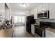 Bright kitchen featuring white cabinets and appliances with view to a breakfast area at 1021 S Fieldhaven Dr, Fuquay Varina, NC 27526