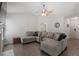 Comfortable living room featuring a large gray sectional sofa and neutral decor at 1021 S Fieldhaven Dr, Fuquay Varina, NC 27526