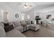 Open living room showing access to the kitchen and dining area, with a large sectional sofa at 1021 S Fieldhaven Dr, Fuquay Varina, NC 27526