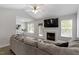 Spacious living room with vaulted ceilings, fireplace, and open access to dining area at 1021 S Fieldhaven Dr, Fuquay Varina, NC 27526