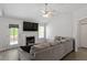 Bright living room with vaulted ceilings, fireplace, and gray sectional sofa at 1021 S Fieldhaven Dr, Fuquay Varina, NC 27526