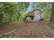 Backyard with a wooden deck, stairs, mature trees, and a partially fenced yard at 104 Farnham Ct, Garner, NC 27529