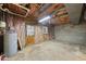 Unfinished basement area with concrete floor, exposed pipes, and a utility area at 104 Farnham Ct, Garner, NC 27529