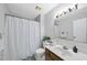Bathroom features a white shower curtain, vanity with sink, and a decorative plant at 104 Farnham Ct, Garner, NC 27529
