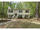 Charming split-level home featuring a well-maintained yard with stone pathway, and a cozy front porch at 104 Farnham Ct, Garner, NC 27529