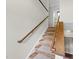 Interior staircase featuring carpeted steps and wood handrails, leading to the upper level of the home at 104 Farnham Ct, Garner, NC 27529