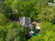Expansive aerial view of the home and backyard with pool, spa, and deck, all nestled within a private, wooded lot at 108 Martinique Pl, Cary, NC 27511