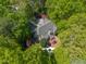 Stunning aerial view of a private residence with a pool, spa, and wooden deck surrounded by lush trees at 108 Martinique Pl, Cary, NC 27511
