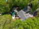 Overhead perspective of the property showcasing a pool, spa, wooden deck, and dense foliage for seclusion at 108 Martinique Pl, Cary, NC 27511