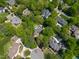 Community aerial view showcasing the property with pool, spa, and backyard nestled in a wooded residential area at 108 Martinique Pl, Cary, NC 27511