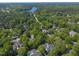 Aerial community shot with the property marked, highlighting the home's location near a lake and surrounded by trees at 108 Martinique Pl, Cary, NC 27511