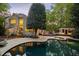 A serene backyard featuring a pool, spa, deck, and gazebo, perfect for outdoor entertaining and relaxation at 108 Martinique Pl, Cary, NC 27511