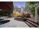 Stunning back exterior featuring a pool, deck, built-in grill, and lush landscaping, perfect for outdoor living at 108 Martinique Pl, Cary, NC 27511