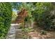 Lush backyard with stone path and arbor for a peaceful outdoor experience at 108 Martinique Pl, Cary, NC 27511