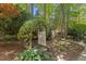 Enchanting backyard garden entrance with a stone path under a trellis covered in vines at 108 Martinique Pl, Cary, NC 27511