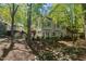 Stunning backyard view with lush landscaping, a deck, and mature trees at 108 Martinique Pl, Cary, NC 27511