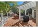 Large backyard deck featuring a covered pergola, outdoor grill, and pool house at 108 Martinique Pl, Cary, NC 27511
