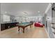 Spacious basement recreation room with pool table, wine storage, and stylish modern furnishings at 108 Martinique Pl, Cary, NC 27511