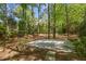 Private basketball court nestled among the trees in a spacious backyard at 108 Martinique Pl, Cary, NC 27511
