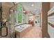 Spa-like bathroom featuring walk-in shower, large soaking tub, and treetop views from large windows at 108 Martinique Pl, Cary, NC 27511