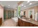 Bright primary bathroom with walk-in shower, soaking tub, granite-top vanity, and ample natural light at 108 Martinique Pl, Cary, NC 27511