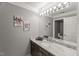 Elegant bathroom features a granite countertop, modern lighting, and a sleek design with gray walls at 108 Martinique Pl, Cary, NC 27511