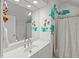 Well-lit bathroom with a large mirror, white countertops, and whimsical tree-themed wall decorations at 108 Martinique Pl, Cary, NC 27511