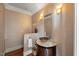 Stylish half-bathroom featuring a unique vessel sink, decorative wall accents, and elegant lighting at 108 Martinique Pl, Cary, NC 27511