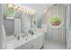 Bright bathroom with a skylight, unique striped wallpaper, and a modern vanity area at 108 Martinique Pl, Cary, NC 27511