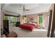 Tranquil bedroom with tray ceilings, a ceiling fan, large windows, and private outdoor views at 108 Martinique Pl, Cary, NC 27511